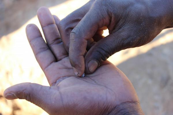 Young miner in Zimbabwe shows mercury coated gold