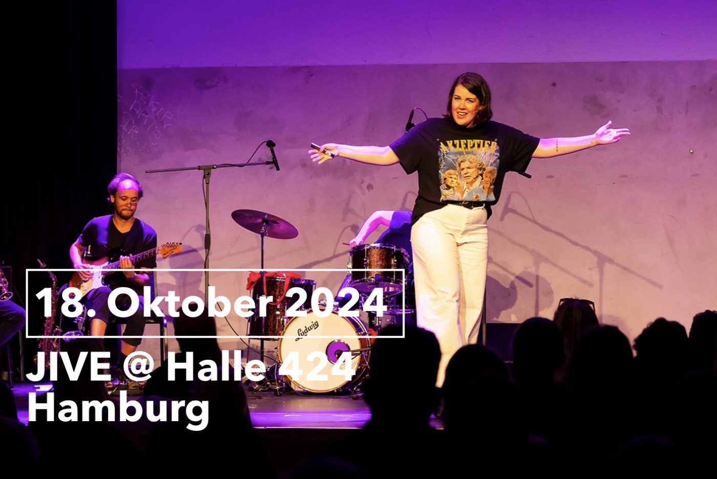 a journalist on stage, musicians behind her