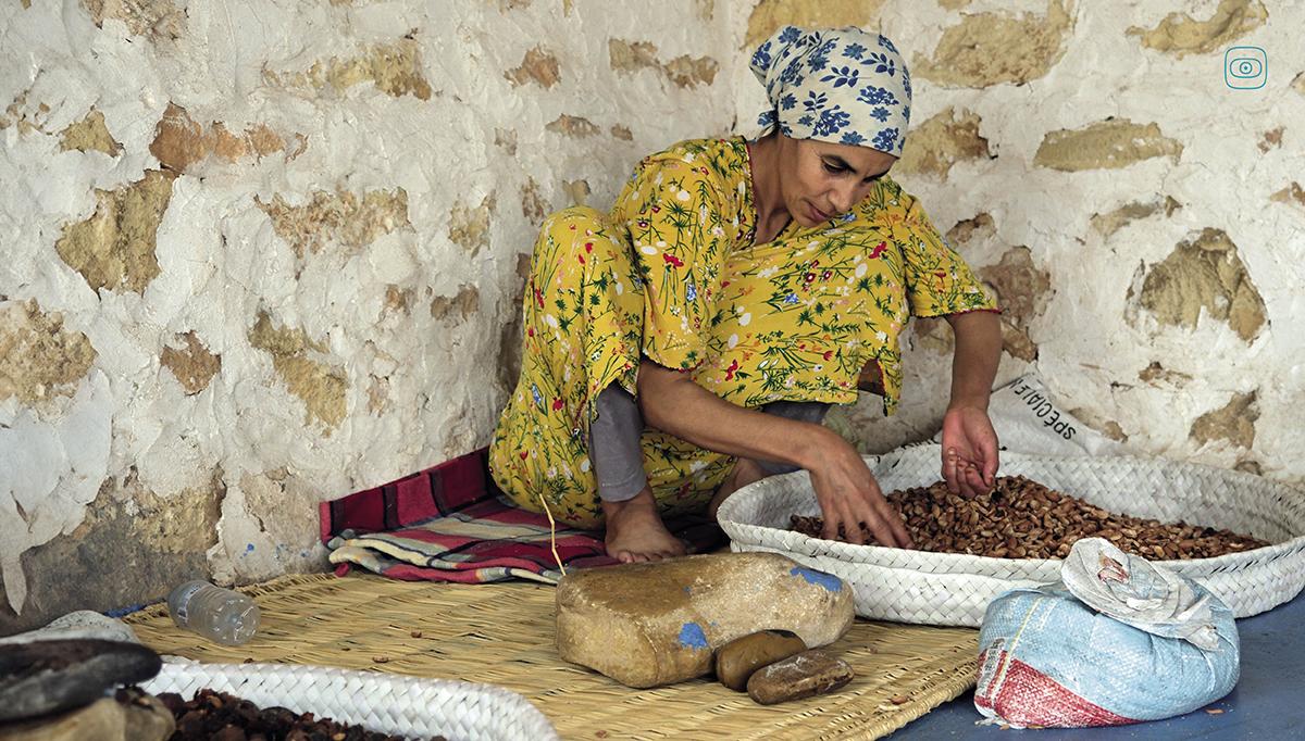 Photo: A woman crushes argan nuts by hand to retrieve the precious kernel, Co-op Ayadi Chiadma, Morocco. Photograph by Juliet Ferguson