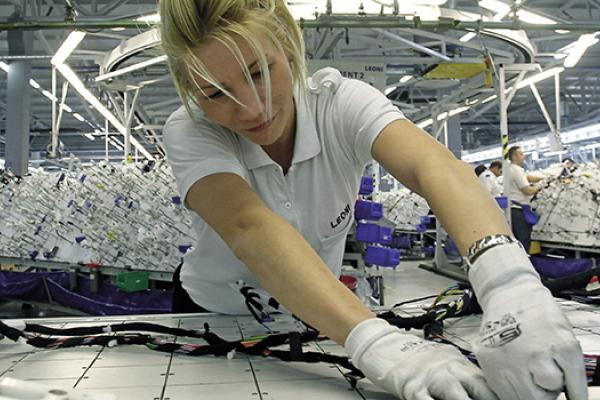 Worker in Leoni factory in Serbia, producing car cables
